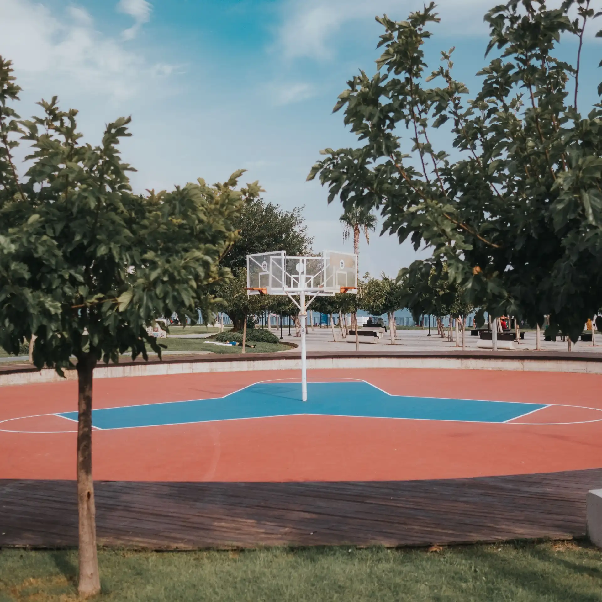 A beautiful outdoor basketball court surrounded by trees
