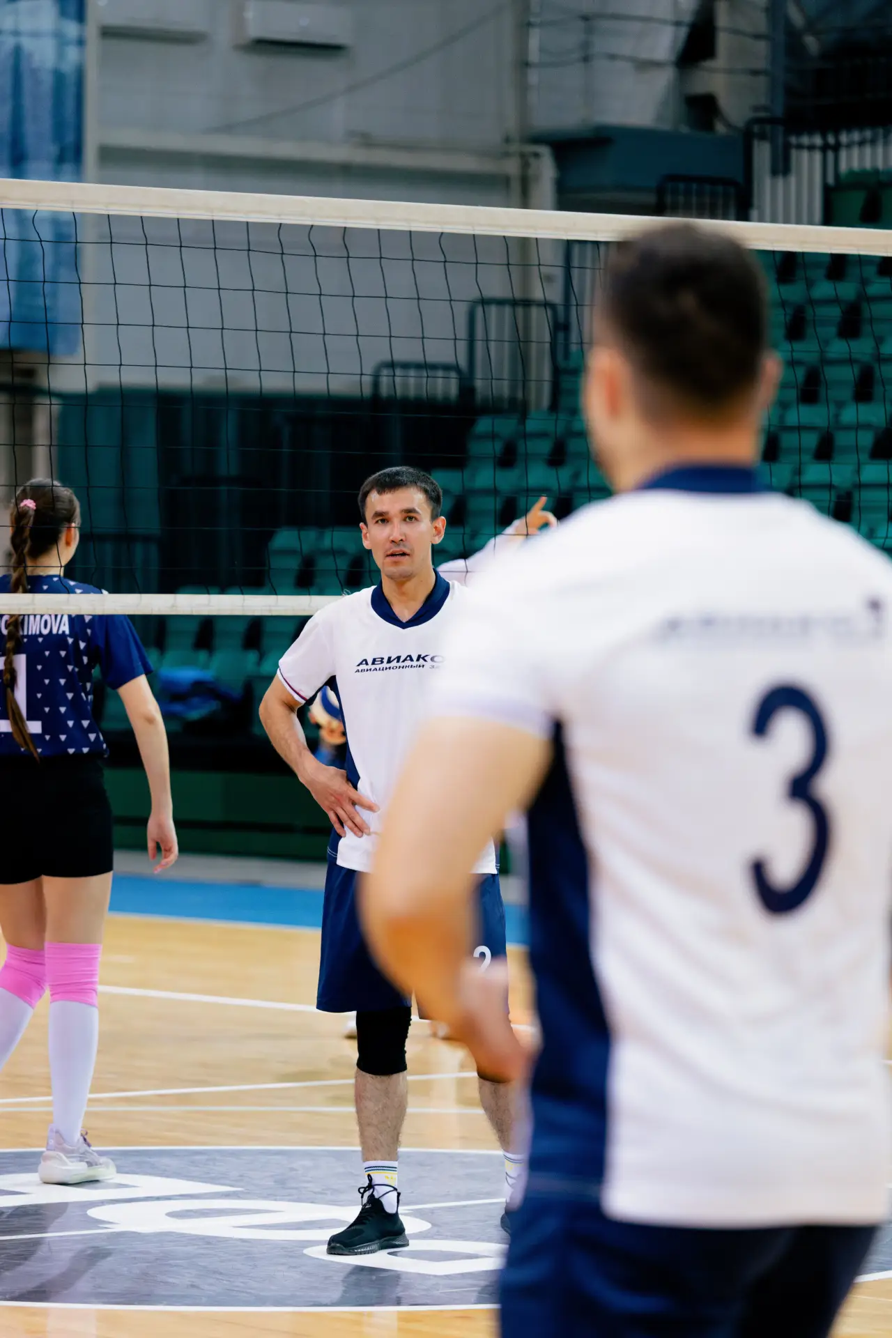 Volleyball players in action on an indoor court