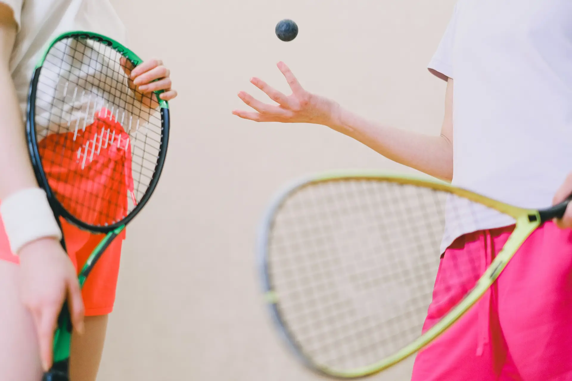 Two tennis players with rackets and a tennis ball